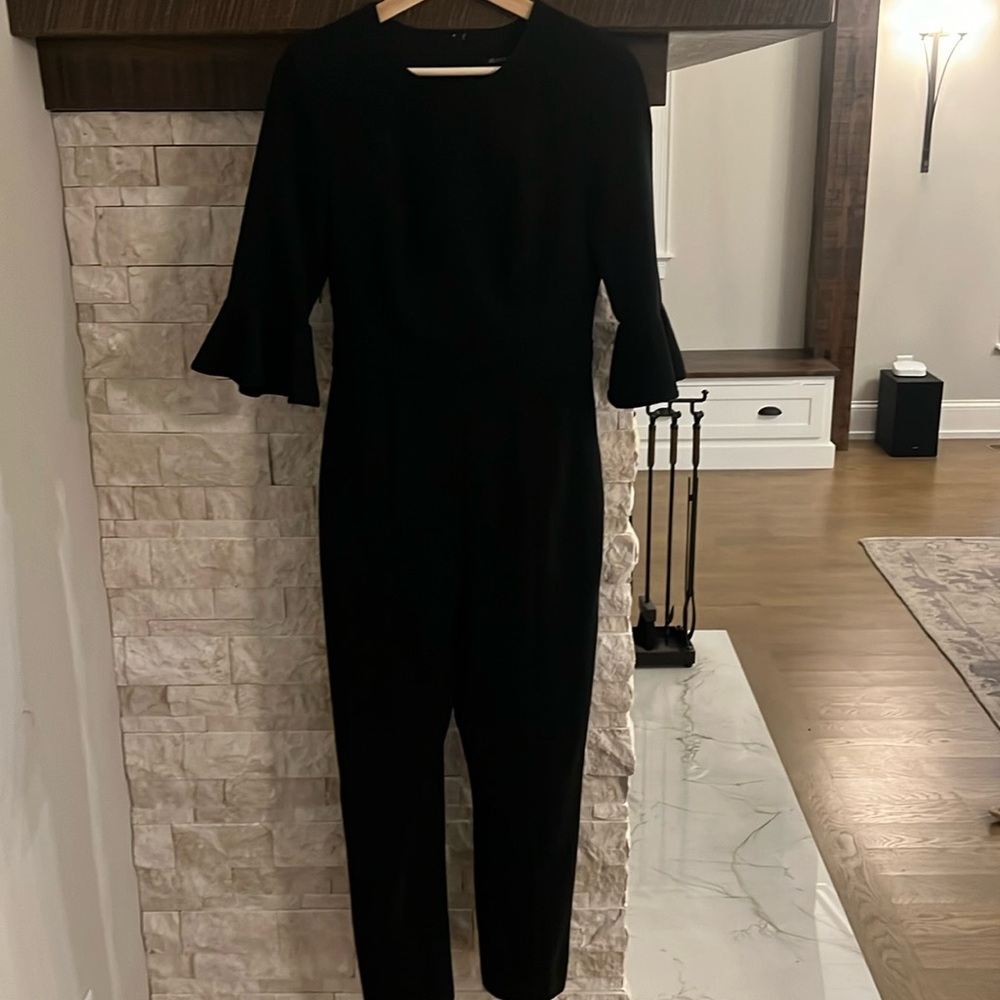 Black Hali jumpsuit. 3/4 flutter sleeves. Pockets. Size 4 P2P 17” L 4’6”